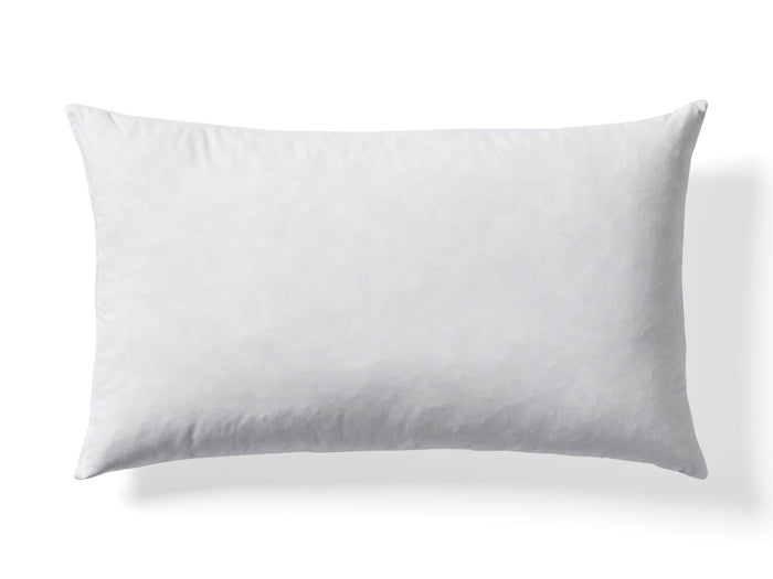 White rectangular pillow on a plain background, showcasing its smooth texture and lightly rounded edges.