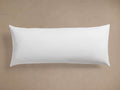 White rectangular Decorative Lumbar Pillow Insert, plump and smooth, centered horizontally on a light brown background.