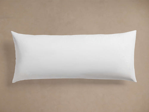 White rectangular Decorative Lumbar Pillow Insert, plump and smooth, centered horizontally on a light brown background.