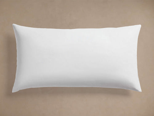 White rectangular Decorative Lumbar Pillow Insert, plump and smooth, centered horizontally on a plain beige background.