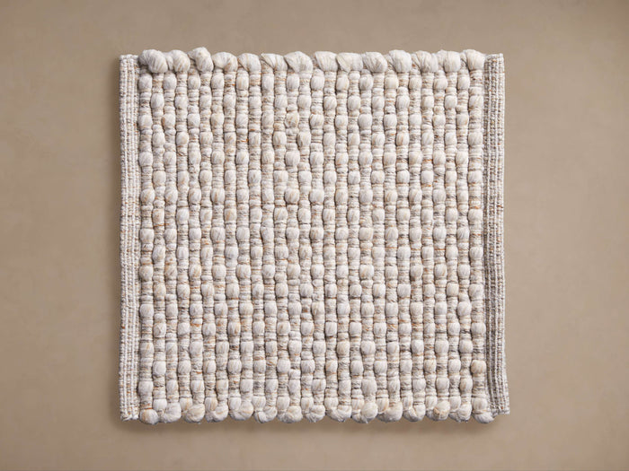 Square Acer Performance Rug Swatch, light beige/off-white with a thick, bobbled, looped weave texture, lying flat.