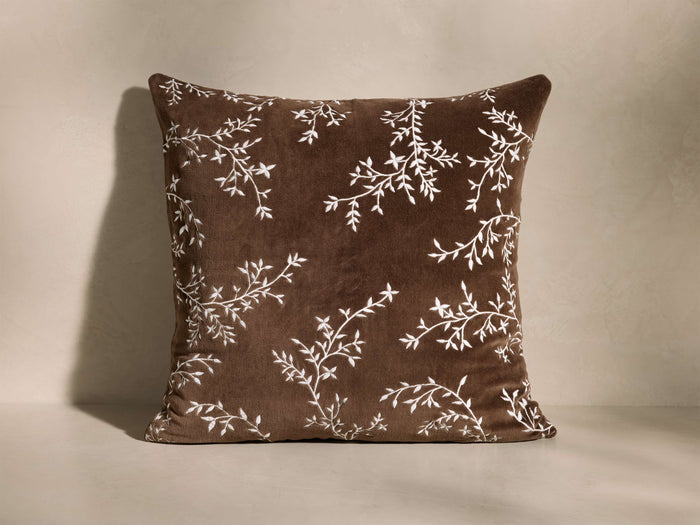 Front view of the brown cotton velvet Aisla Pillow with an embroidered ivory botanical design.