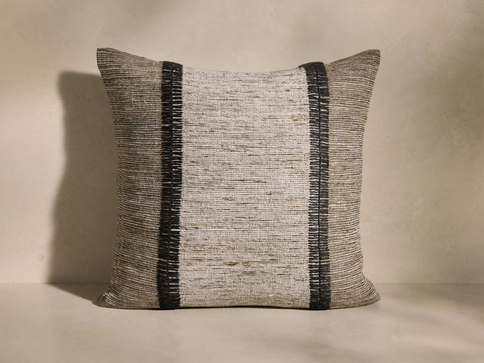 Front view of the Akara Embroidered Pillow, featuring textured ivory raw silk with two vertical onyx paneled embroidery stripes.