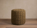 Front view of a round olive brown ottoman with a textured square grid pattern.