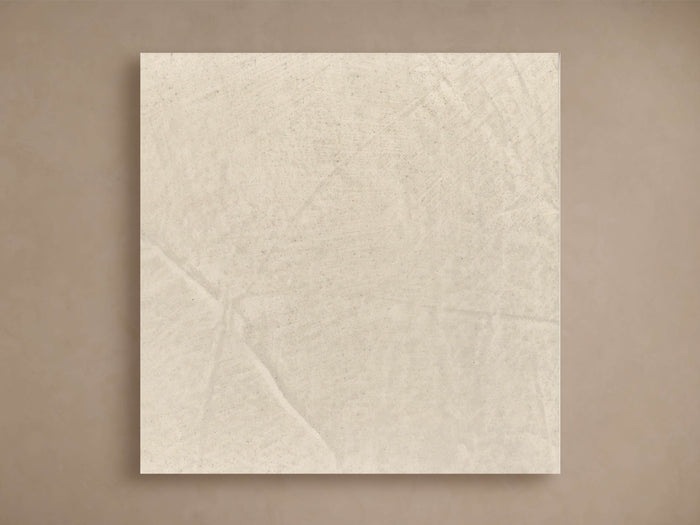 Square Alesso Outdoor Finish Board in light grey stone, showing subtle textured variations, leaning on a neutral brown wall.
