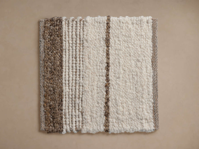 Alice Performance Rug Swatch: Cream and brown textured, looped pile swatch with varied striped patterns, laid flat.
