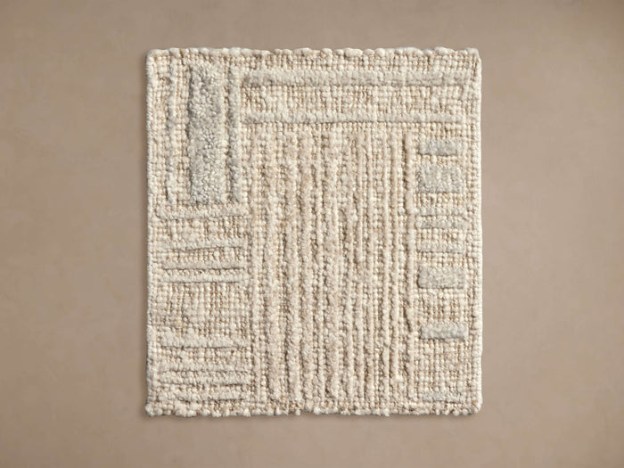 Alta Hand-Knotted Rug Swatch in beige with a textured, linear pattern. Rectangular, showcasing stitches and construction detail.