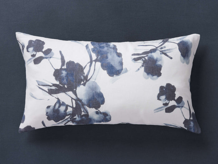 Amal Linen Sham on dark surface, with a digital floral pattern in shades of blue, featuring a rectangular shape.