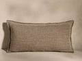 Front view of the neutral beige Anova Pillow, featuring a woven jacquard texture with horizontal patterns and frayed edges.