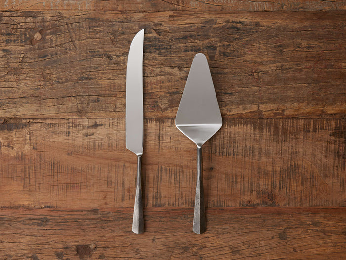 Arber Cake Server set of two, featuring a knife and server with distressed handles, mirror-polished tops on wooden surface.