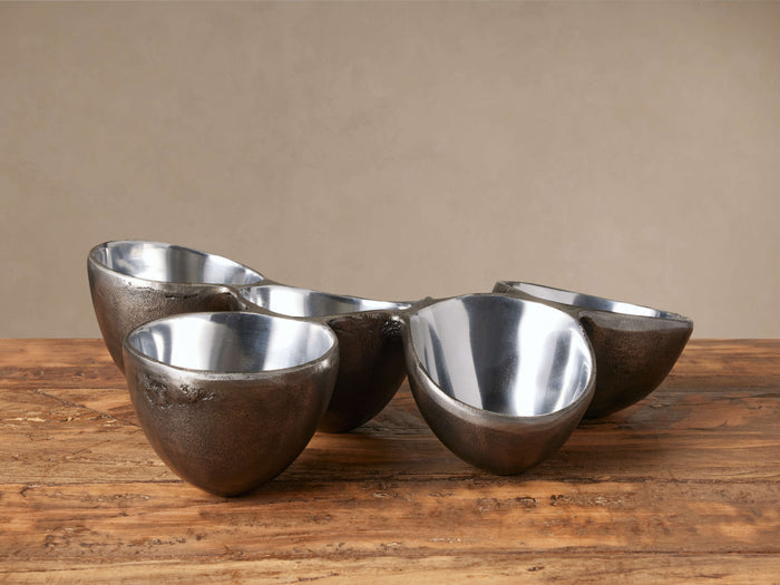 Arber Organic 5-section serving dish, dark textured aluminum exterior, shiny silver polished interiors, on a wooden surface.