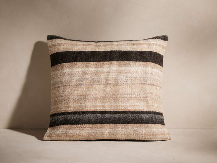 Square Aris Stripe Pillow with woven texture, featuring horizontal stripes in natural beige, light brown, and dark charcoal.