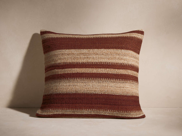 Aris Variegated Stripe Pillow, square, featuring alternating horizontal stripes of deep reddish-brown and textured beige.