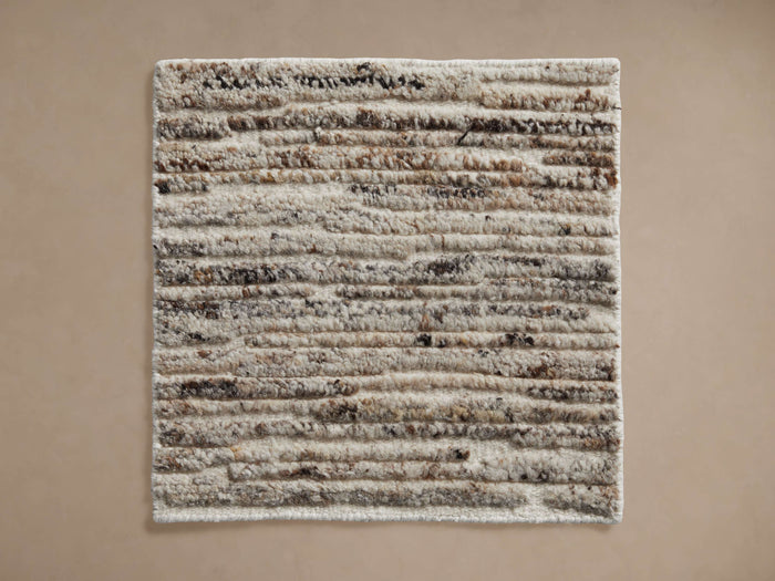 Arlo Hand-Knotted Rug Swatch. Cream square swatch with plush horizontal brown & black textured rows, viewed from above.