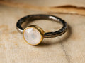 Arne Moonstone Ring: Round, faceted moonstone in gold bezel setting on a dark, hammered band with smoky pewter finish.
