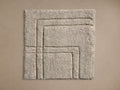 Asher Hand-Knotted Rug Swatch in beige, showing a textured, layered square pattern on a neutral background.