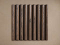 Astor Finish Board: Dark brown fluted wood panel with textured grain, centered against a light brown background.