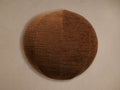 Atwood Sphere Pillow, a round dark brown pillow with ribbed, textured fabric, centered against a neutral wall.