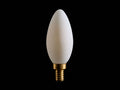 A white, teardrop-shaped LED bulb with a gold screw base, displayed against a black background.