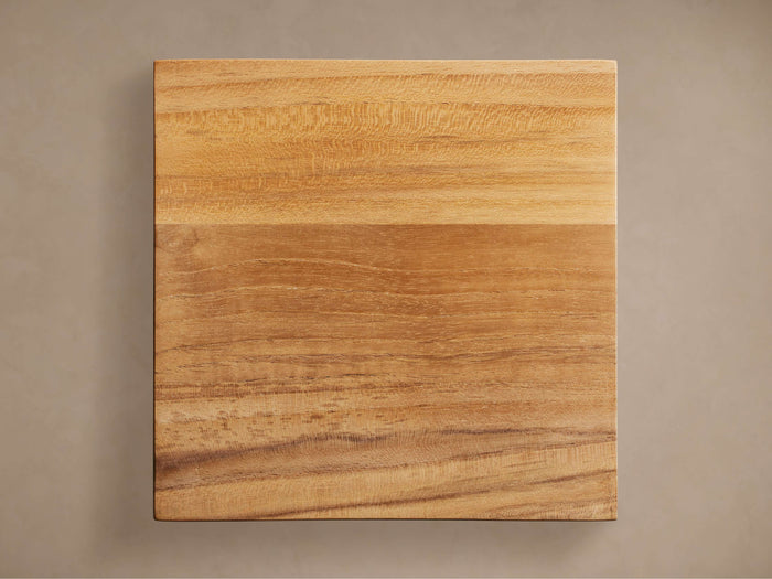 Montego Outdoor Teak Finish Board, square and flat, displaying rich warm brown natural wood grain against a neutral background.