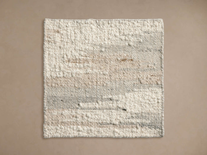 Bowyn Rug Swatch featuring a textured cream surface with subtle beige and grey accents, on a neutral background.
