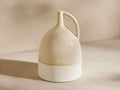 Bronwen Jug Vase: artisan ceramic jug vase, glossy creamy beige top, matte speckled white base, and arched handle.