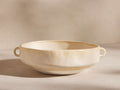 Bronwen Low Pot: Wide, low ceramic pot with two loop handles, glazed creamy yellow, handcrafted texture on a light background.