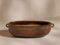 Bronwen Trough Planter in warm brown glaze, oval shape, with two side handles on a light background.