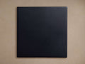Dark blue-black Cadence Finish Board, square, with a smooth matte finish, centered against a light beige background.
