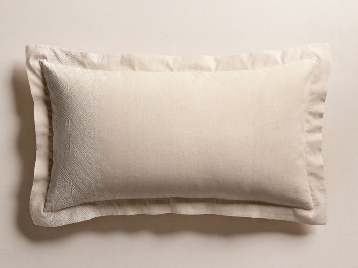 Natural Cadre Sham with tone-on-tone geometric embroidery in the corner and a subtle flange edge, lying flat.