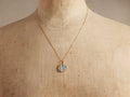 Cairn Abstract Necklace: gold chain, circular pendant with raw diamond/silver mosaic & vertical champagne diamond strips on bust.