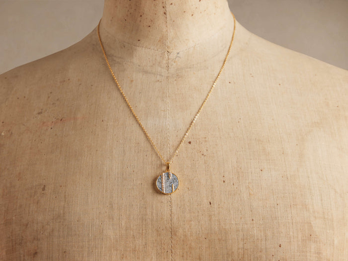 Cairn Abstract Necklace: gold chain, circular pendant with raw diamond/silver mosaic & vertical champagne diamond strips on bust.