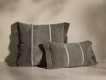 Front view of two gray suede Calais Pillows, one square, one rectangular, with flange edges and white vertical contrast stripes.