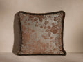 Camellia Fringe Pillow with a woven jacquard floral motif in neutral hues, featuring a coordinating fringe edge, on a plain surface.