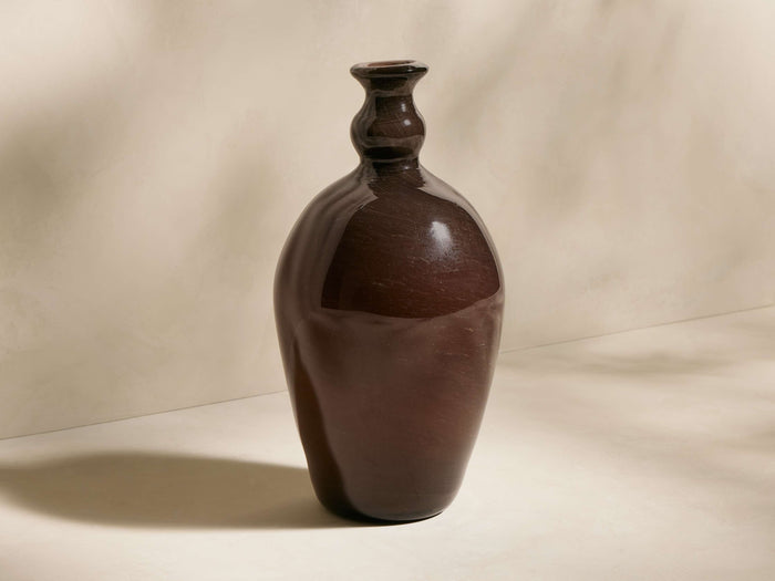 Handcrafted Cassia Bottle-Neck Vase made of translucent dark brown recycled glass, bulbous body, narrow fluted neck.