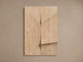 Cassian Carving: a light natural-colored wooden rectangular panel with an organic, wavy vertical carving on a neutral wall.