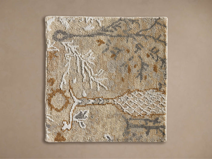 Close-up of a textured Casteel Hand-Knotted Rug Swatch with an abstract tree pattern in beige, brown, grey, and off-white.