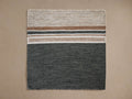 Cielo Performance Rug Swatch, rectangular woven fabric. Top half: light beige with horizontal tan, thin black, white stripes. Bottom half: solid dark gray.