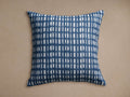 Square Cielos Outdoor Pillow in navy blue & white, geometric grid pattern of vertical lines & stacked half-circles, knife-edge.
