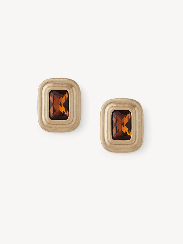 A pair of gold-toned rectangular stud earrings with faceted amber-brown crystal centers, displayed on a clean off-white background.