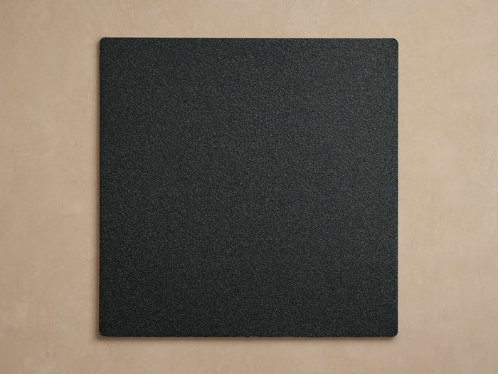 Coden Outdoor Finish Board, a dark gray square with a pebbled texture and slightly rounded corners, centered on a light beige background.