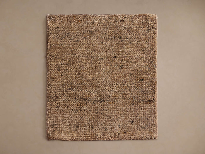 Coleman Hand-Knotted Rug Swatch, displaying a textured surface with various shades of brown and beige, on a neutral background.