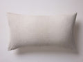 Cosette Sham in a light beige color, featuring a subtle woven texture. Rectangular with a center envelope closure, on a white background.