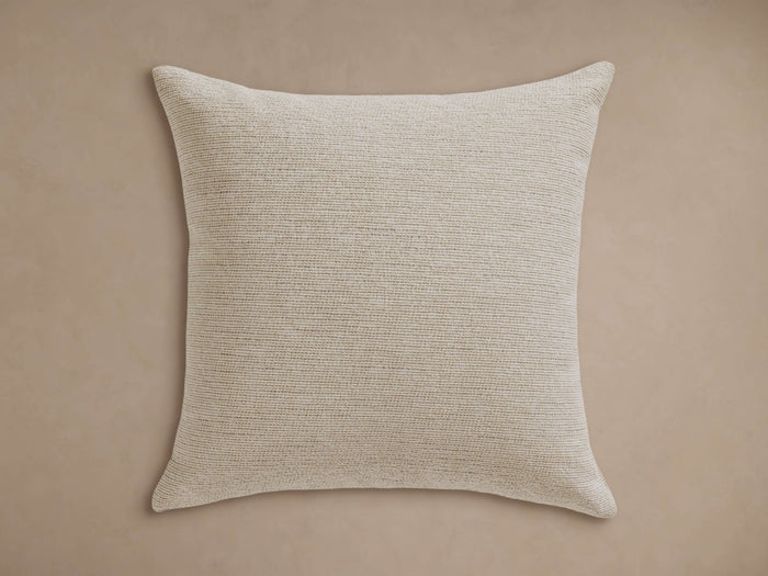 Dani Outdoor Pillow, square, light beige with fine horizontal woven texture, centered on a solid neutral background.