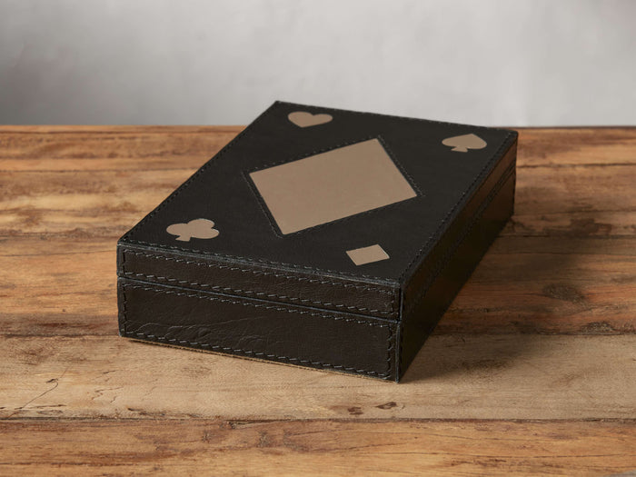 Angled top view of the black leather Dawson Card Box featuring tan card suit symbols on its lid.