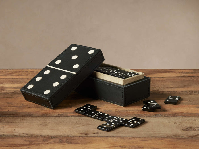 Dawson Domino Box: Open black leather box with suede interior, double-six domino lid, and black & white dominoes on wood.
