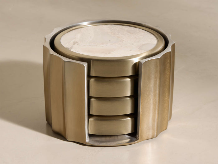 Angled view of Dayana Coasters (Set of 4) in a brass fluted holder with cream natural marble stone inlays.