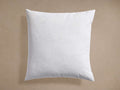 Front view of a white Decorative Pillow Insert, square and plump, with cotton down-proof cover and piping.