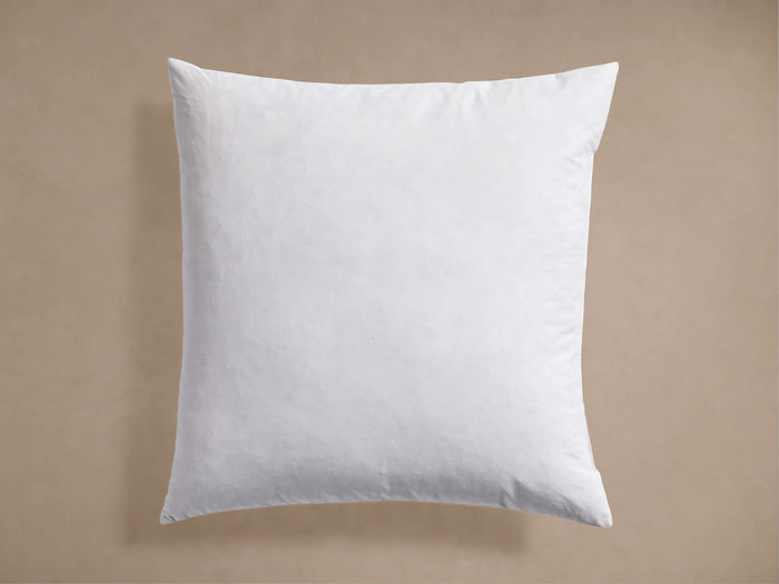 Front view of a white Decorative Pillow Insert, square and plump, with cotton down-proof cover and piping.
