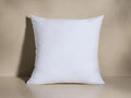 Front view of a white, square pillow insert with soft, slightly pointed corners.